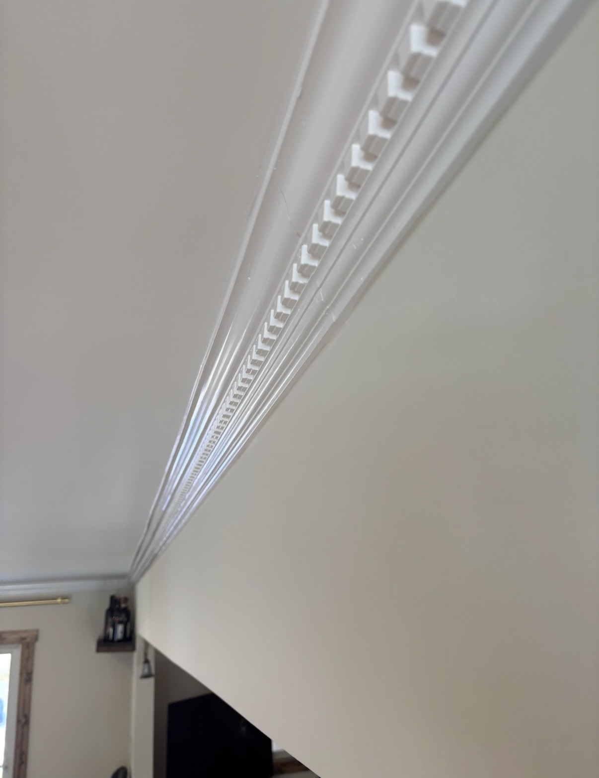 Detailed dentil crown molding running along the ceiling line