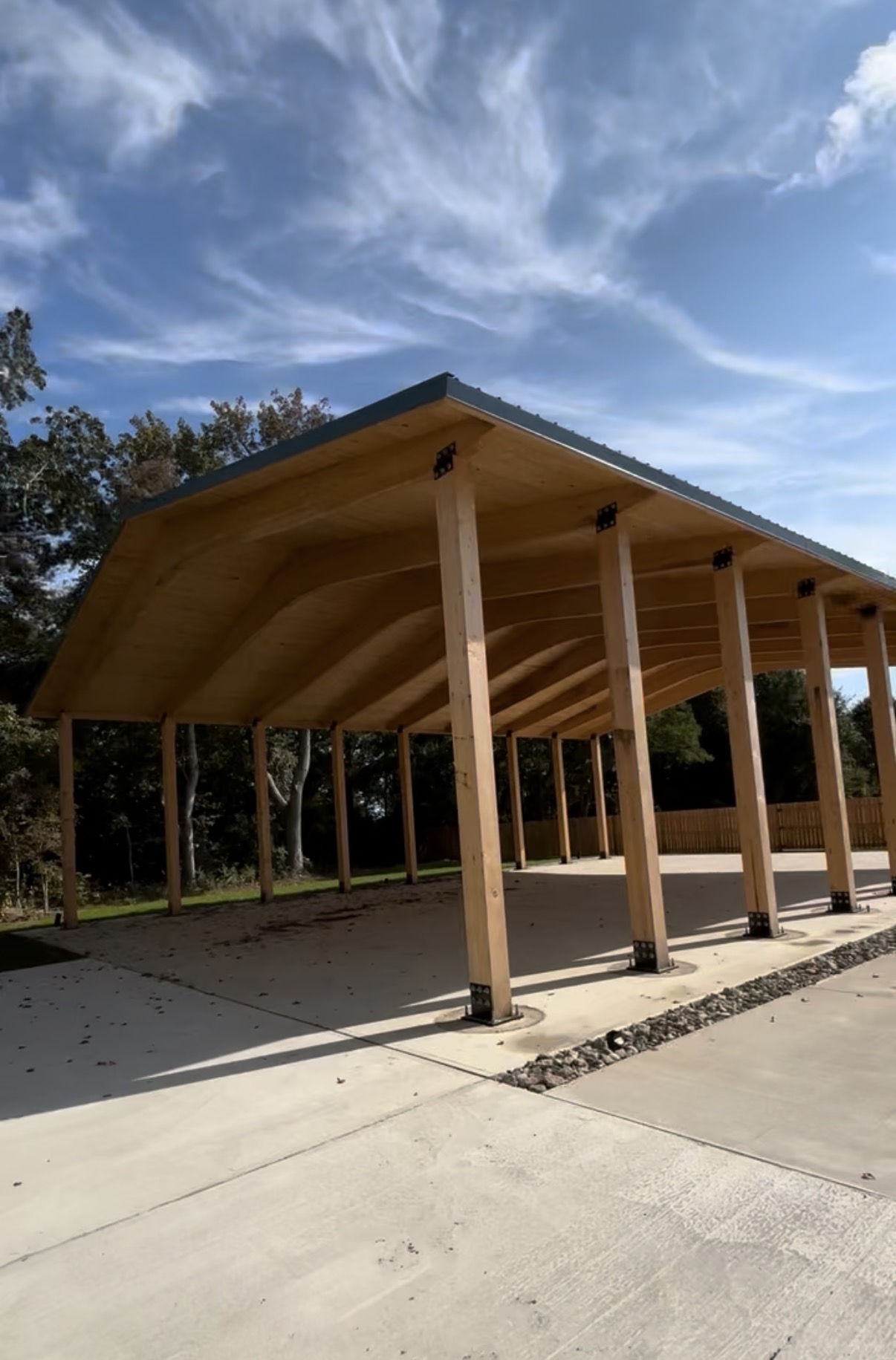 Completed glulam timber-frame pavilion from the side
