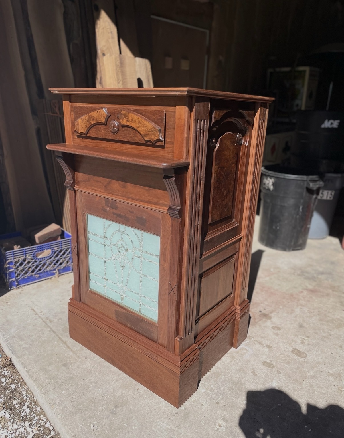 Front view of the finished oak podium with leaded-glass panel and burl inlay