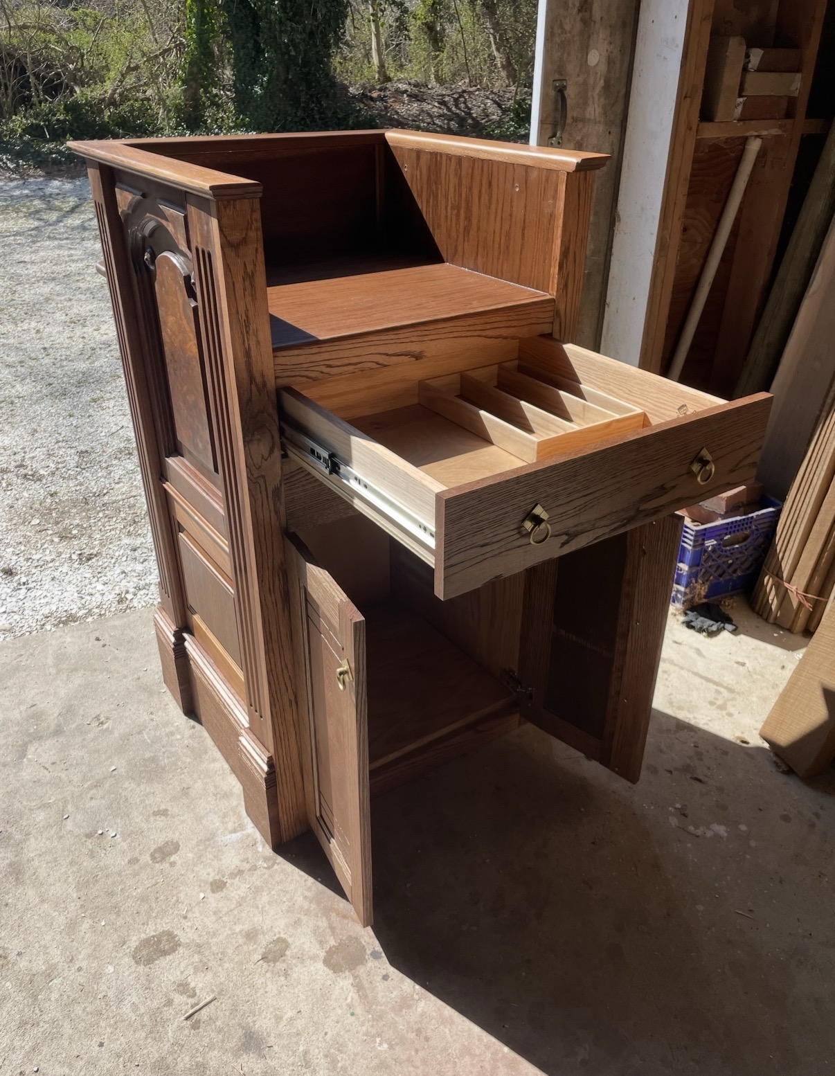 Podium with the drawer pulled out showing the custom tray organizer